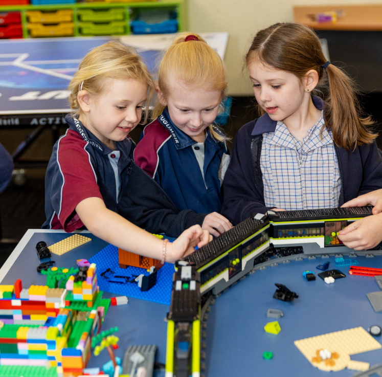 students looking at Lego train
